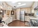 Bright kitchen features stainless steel appliances, wood look flooring, and ample cabinet storage at 12501 Ulmerton Rd # 110, Largo, FL 33774