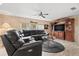 Spacious living room featuring an entertainment center, comfortable seating, and ample natural light at 12501 Ulmerton Rd # 110, Largo, FL 33774