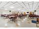 Large community meeting room furnished with tables and chairs, suitable for gatherings and events at 12501 Ulmerton Rd # 110, Largo, FL 33774