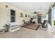 Cozy covered patio area with comfortable seating, a ceiling fan, and space to relax and enjoy the outdoors at 12501 Ulmerton Rd # 110, Largo, FL 33774