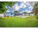 Backyard with a lush lawn, mature landscaping, and pool at 13296 88Th N Ave, Seminole, FL 33776