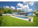 Backyard featuring a pool surrounded by well-maintained lawn and patio at 13296 88Th N Ave, Seminole, FL 33776