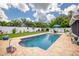 Backyard featuring a pool surrounded by well-maintained lawn and patio at 13296 88Th N Ave, Seminole, FL 33776