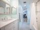 Bright bathroom with white vanity, tub/shower combo, and aqua accent tiles at 13296 88Th N Ave, Seminole, FL 33776