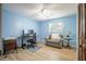 Bright bedroom featuring a ceiling fan, desk with computer, and comfortable chair at 13296 88Th N Ave, Seminole, FL 33776