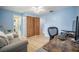 Another view of bedroom with a desk, chair, and closet with wood-paneled doors at 13296 88Th N Ave, Seminole, FL 33776