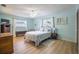 Light-filled bedroom with neutral colors, wood flooring, and a ceiling fan at 13296 88Th N Ave, Seminole, FL 33776