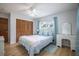 Comfortable bedroom featuring a closet with wood-paneled doors and a white vanity at 13296 88Th N Ave, Seminole, FL 33776