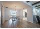 Bright dining area featuring wood floors, a decorative chandelier, and an adjacent kitchen at 13296 88Th N Ave, Seminole, FL 33776