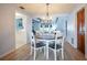 Cozy dining area with an elegant chandelier, wood floors, and views to the kitchen at 13296 88Th N Ave, Seminole, FL 33776