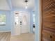 Bright foyer with an decorative front door, light blue walls, and tile flooring at 13296 88Th N Ave, Seminole, FL 33776