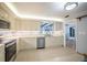 Kitchen with stainless steel appliances, tile floors, and white cabinets at 13296 88Th N Ave, Seminole, FL 33776