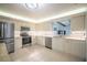 Bright kitchen with stainless steel appliances, white cabinets, tile backsplash and tile floor at 13296 88Th N Ave, Seminole, FL 33776