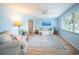 Bright living room with light blue walls, wood floors, and natural light from the window at 13296 88Th N Ave, Seminole, FL 33776