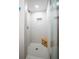 Modern shower with white subway tile, glass door, and a wooden shower seat at 13296 88Th N Ave, Seminole, FL 33776