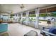 Sunroom with travertine tile, ceiling fans, and curtains that open to the pool and backyard at 13296 88Th N Ave, Seminole, FL 33776