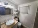 Bathroom featuring a vessel sink, large mirror, and a convenient storage shelf with towels at 1335 Waikiki Way, Tampa, FL 33619