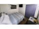 Cozy bedroom with window, television, and closet at 1335 Waikiki Way, Tampa, FL 33619