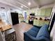 Kitchen featuring sage green cabinets, modern appliances, breakfast bar, and stylish furnishings at 1335 Waikiki Way, Tampa, FL 33619