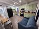 Bright eat-in kitchen features green cabinets, stainless appliances, and bar-style seating at 1335 Waikiki Way, Tampa, FL 33619