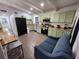 Kitchen featuring sage green cabinets, modern appliances, breakfast bar, and stylish furnishings at 1335 Waikiki Way, Tampa, FL 33619