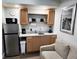 Efficient kitchenette with wood cabinets and modern appliances at 1335 Waikiki Way, Tampa, FL 33619