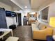Cozy living space with a comfortable couch and a sleek, modern kitchen equipped with stainless steel appliances at 1335 Waikiki Way, Tampa, FL 33619