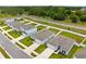Aerial shot of houses showing modern homes, manicured lawns, and nearby roads in a suburban community at 14532 Whitewater Way, Brooksville, FL 34604
