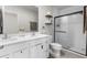 Modern bathroom with double sinks, white cabinets, and a glass-enclosed shower at 14532 Whitewater Way, Brooksville, FL 34604
