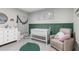 Cozy Bedroom featuring a crib, rocking chair, and soft accents at 14532 Whitewater Way, Brooksville, FL 34604