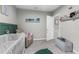 Well-decorated Bedroom with a crib, recliner, and ample storage at 14532 Whitewater Way, Brooksville, FL 34604