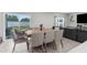 Open dining area with sliding glass doors to the backyard and modern furnishings at 14532 Whitewater Way, Brooksville, FL 34604