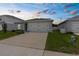 Charming home with a two-car garage and well-maintained lawn presents a welcoming exterior at 14532 Whitewater Way, Brooksville, FL 34604