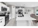 Stylish kitchen with white cabinets, stainless steel appliances, and a breakfast bar island at 14532 Whitewater Way, Brooksville, FL 34604