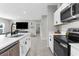 Bright kitchen featuring white cabinetry, black appliances, and an island with seating at 14532 Whitewater Way, Brooksville, FL 34604