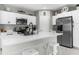 Beautiful kitchen showcasing white cabinetry, stainless steel appliances, and modern fixtures at 14532 Whitewater Way, Brooksville, FL 34604