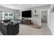 Spacious living room with a large TV, comfortable couch, and natural light at 14532 Whitewater Way, Brooksville, FL 34604