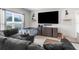 Cozy living room with a large window, sectional couch, and modern entertainment center at 14532 Whitewater Way, Brooksville, FL 34604