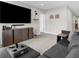 Comfortable living room featuring tile floors, gray walls, and a large entertainment center at 14532 Whitewater Way, Brooksville, FL 34604