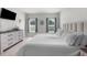 Comfortable main bedroom features neutral tones, soft lighting, and wood flooring at 14532 Whitewater Way, Brooksville, FL 34604