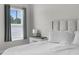Bright main bedroom features a window, light-colored walls, and a plush headboard at 14532 Whitewater Way, Brooksville, FL 34604