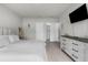 Spacious main bedroom with wood floors, a television, and an en-suite bathroom at 14532 Whitewater Way, Brooksville, FL 34604