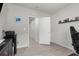 Bright office space with a connecting door, light wood floors, and neutral walls at 14532 Whitewater Way, Brooksville, FL 34604