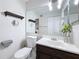 Bathroom showcasing a wide mirror, dark wooden fixtures, and ample lighting at 147 114Th Ne Ave # 147, St Petersburg, FL 33716