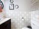 Half bathroom with a wood vanity, updated mirror and wall decorations at 147 114Th Ne Ave # 147, St Petersburg, FL 33716