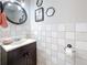 Half bathroom with a wood vanity, updated mirror and decoratives at 147 114Th Ne Ave # 147, St Petersburg, FL 33716