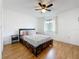 Bright bedroom featuring a ceiling fan, wood floors, and a window for natural light at 147 114Th Ne Ave # 147, St Petersburg, FL 33716