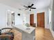 Bedroom featuring laminate floors, ceiling fan, closet and a small desk at 147 114Th Ne Ave # 147, St Petersburg, FL 33716