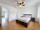 Bedroom with wood floor, ceiling fan, and ensuite access at 147 114Th Ne Ave # 147, St Petersburg, FL 33716
