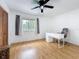 Bedroom featuring laminate floors, a ceiling fan, and a sun-filled window at 147 114Th Ne Ave # 147, St Petersburg, FL 33716